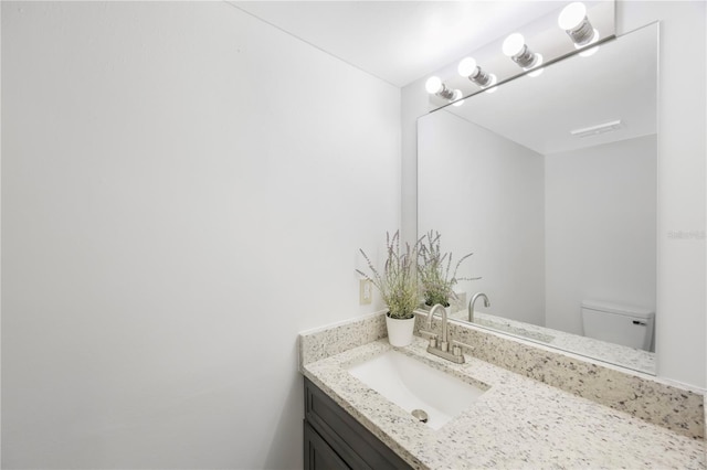 bathroom with vanity and toilet