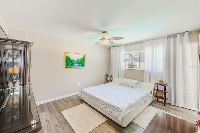 bedroom with ceiling fan and light wood-type flooring