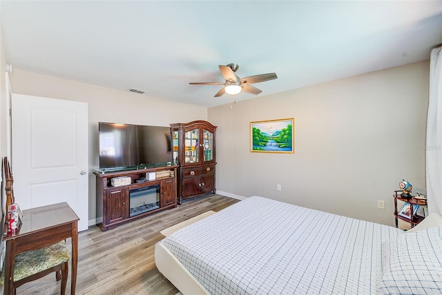 bedroom with ceiling fan and light wood-type flooring