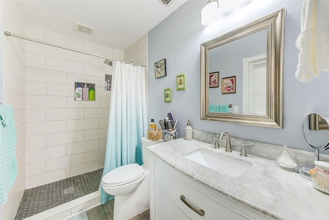 bathroom with vanity, curtained shower, and toilet