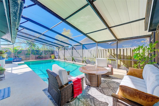 view of swimming pool featuring outdoor lounge area, a patio area, and glass enclosure