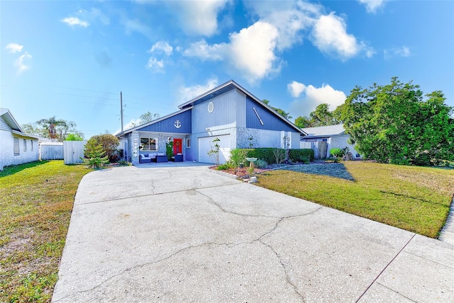 view of front of home featuring a garage and a front lawn