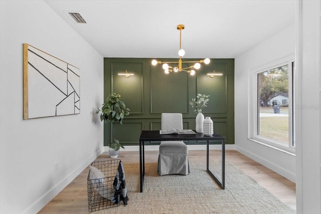 office area with hardwood / wood-style flooring and a notable chandelier