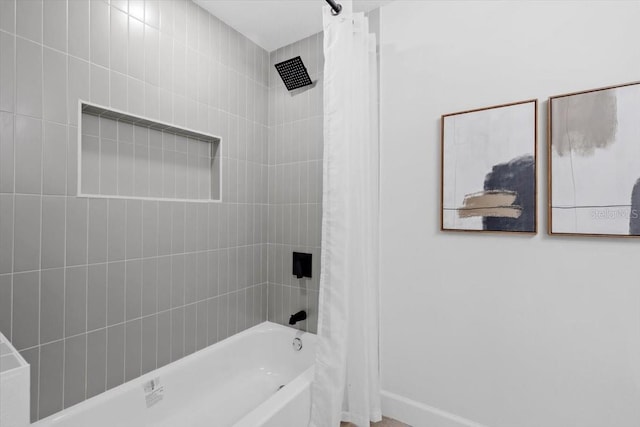 bathroom with shower / bath combo with shower curtain