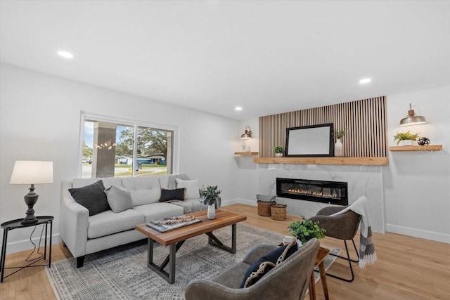 living room with wood-type flooring and a premium fireplace