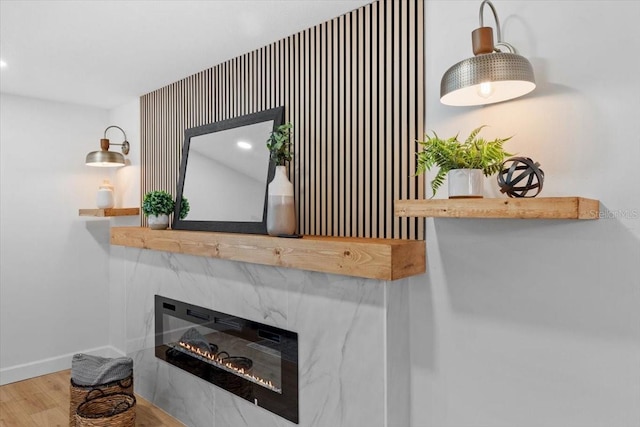 room details featuring hardwood / wood-style flooring and a tiled fireplace