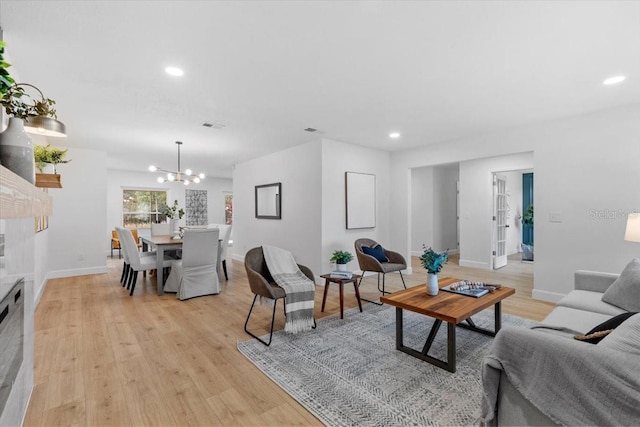 living room featuring light hardwood / wood-style floors and a chandelier