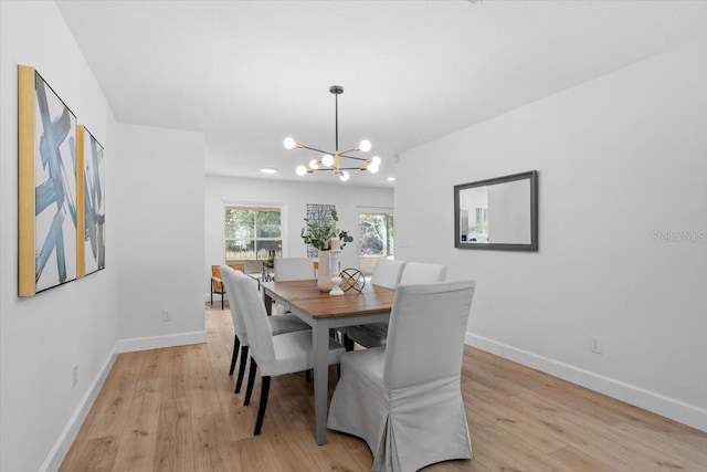 dining room with an inviting chandelier and light wood-type flooring