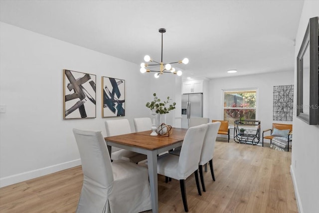 dining room with an inviting chandelier and light wood-type flooring