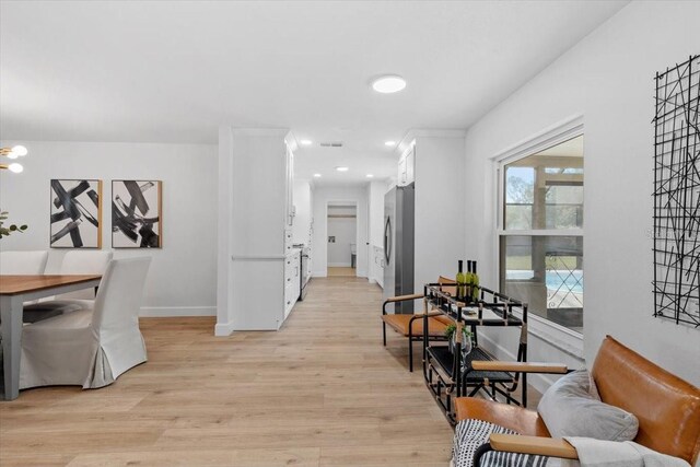 hallway with light hardwood / wood-style flooring