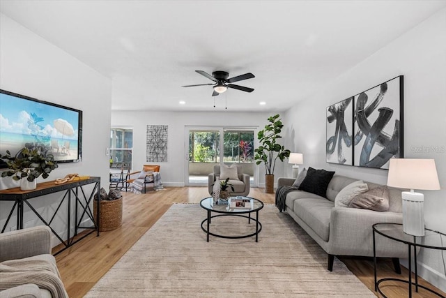 living room with ceiling fan and light wood-type flooring