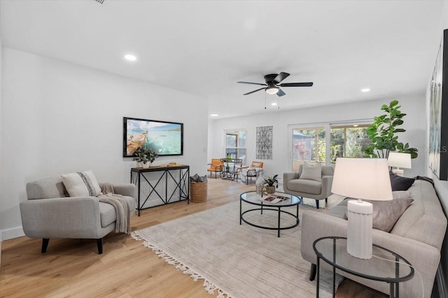 living room featuring ceiling fan and light wood-type flooring