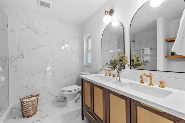 bathroom featuring toilet, vanity, tile walls, and walk in shower