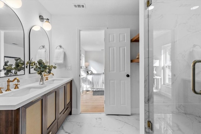 bathroom with a shower with shower door and vanity