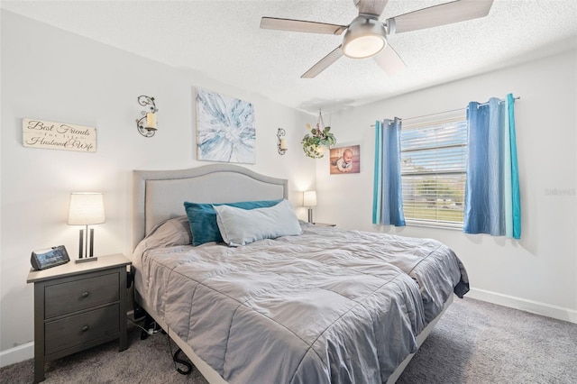 bedroom with a textured ceiling, light colored carpet, and ceiling fan