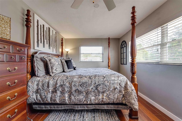 bedroom featuring a textured ceiling, hardwood / wood-style floors, and ceiling fan