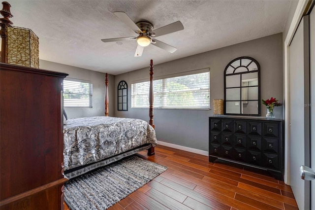 bedroom featuring a textured ceiling, ceiling fan, a closet, and hardwood / wood-style floors