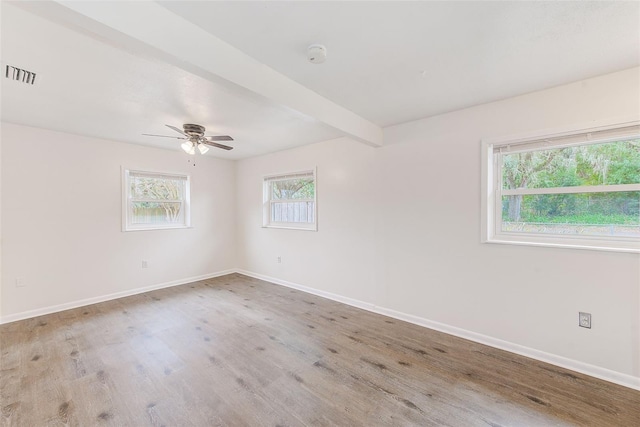 unfurnished room with ceiling fan, beamed ceiling, and light wood-type flooring