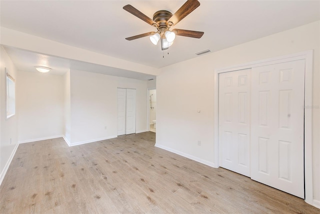 empty room featuring light wood-type flooring and ceiling fan