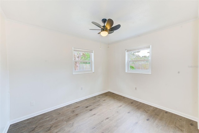 unfurnished room with ceiling fan, wood-type flooring, and plenty of natural light