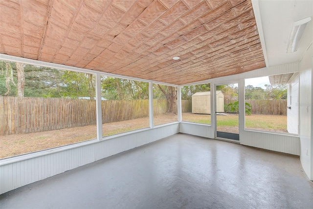 unfurnished sunroom featuring vaulted ceiling and wooden ceiling