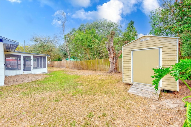 view of yard with a storage unit and a sunroom