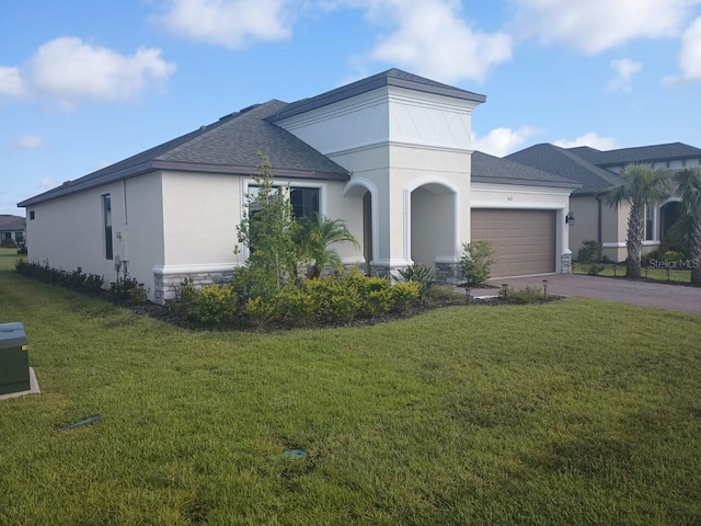 view of front facade with a garage and a front yard