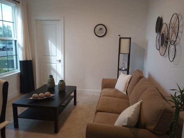 living room featuring a wealth of natural light and light tile patterned floors