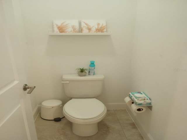 bathroom featuring toilet and tile patterned flooring