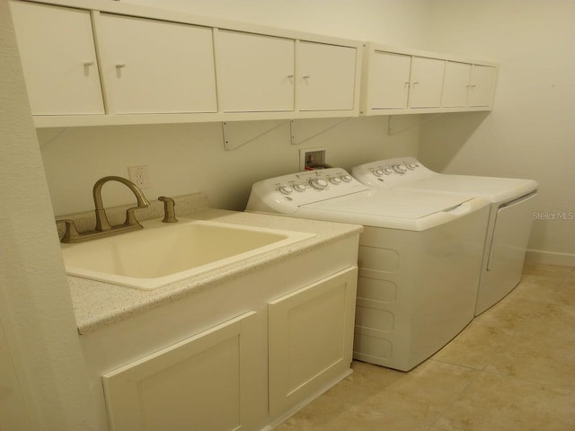 clothes washing area featuring cabinets, separate washer and dryer, and sink