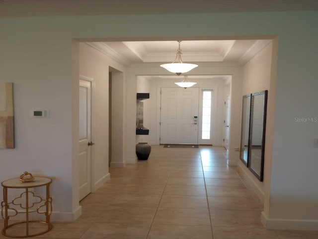 621 San Augusto Dr, Poinciana, FL 34759 - foyer featuring a raised ceiling, ornamental molding, and baseboards
