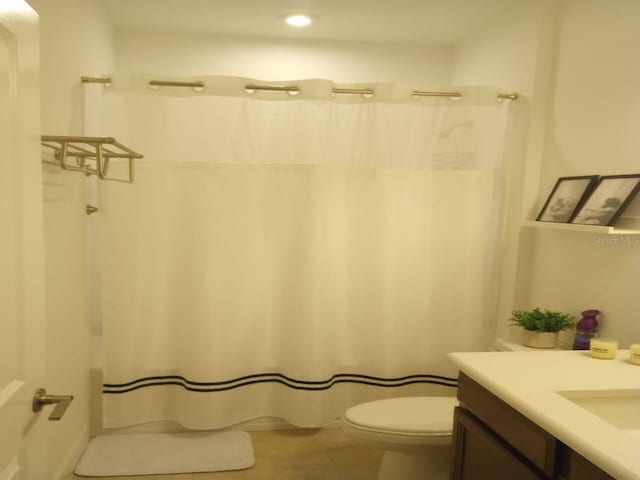 621 San Augusto Dr, Poinciana, FL 34759 - bathroom with curtained shower, toilet, recessed lighting, tile patterned floors, and vanity