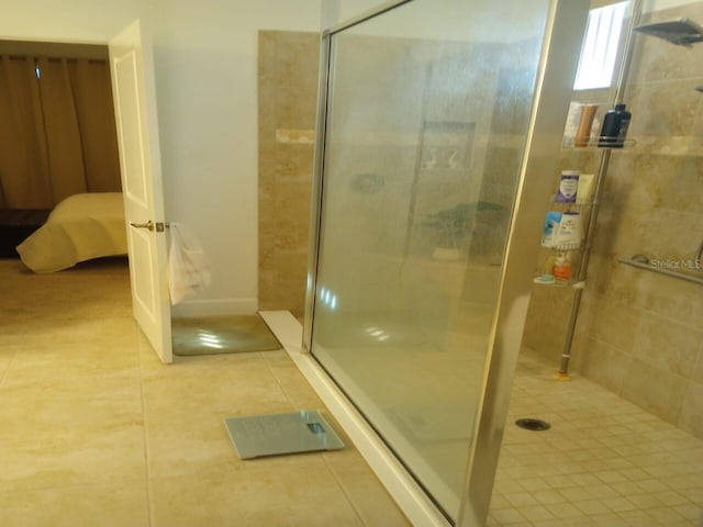 621 San Augusto Dr, Poinciana, FL 34759 - bathroom featuring tile patterned floors, baseboards, and a stall shower