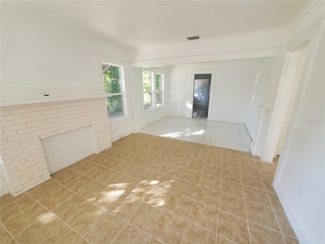 unfurnished living room featuring a fireplace and light tile patterned floors