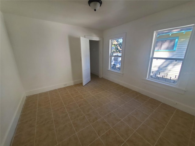 unfurnished room featuring tile patterned flooring