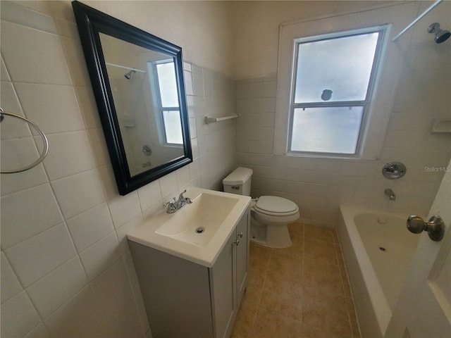 full bathroom with toilet, tile patterned floors, vanity, tile walls, and  shower combination