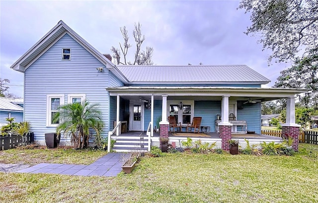 view of front facade with a front yard and covered porch