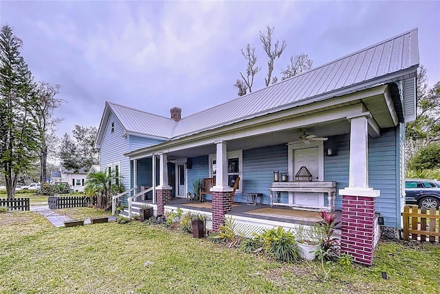 view of front of home with a porch and a front lawn