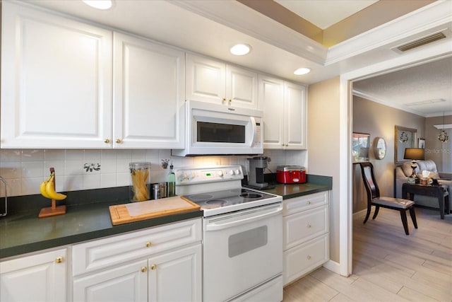 kitchen with white appliances, light wood-type flooring, backsplash, crown molding, and white cabinets