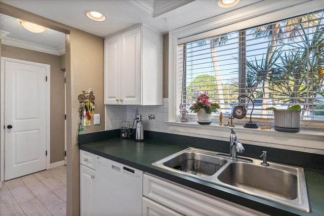 kitchen with sink, white cabinets, tasteful backsplash, white dishwasher, and crown molding