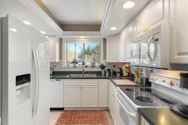 kitchen featuring white appliances, sink, and white cabinetry