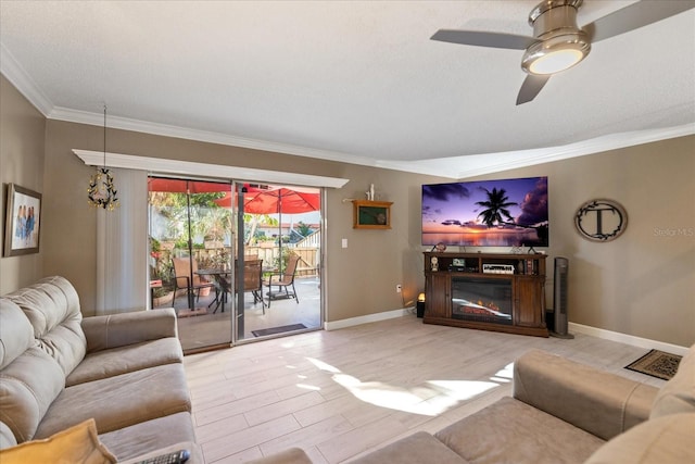 living room featuring ceiling fan, light hardwood / wood-style floors, and crown molding