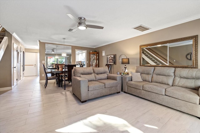 living room with ceiling fan, light wood-type flooring, and crown molding