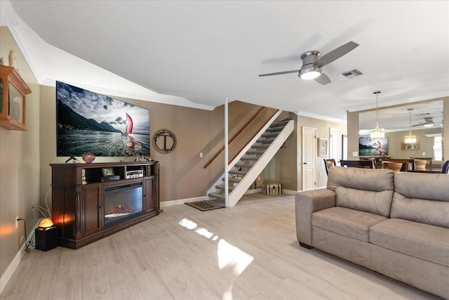 living room with ceiling fan, light hardwood / wood-style flooring, and crown molding