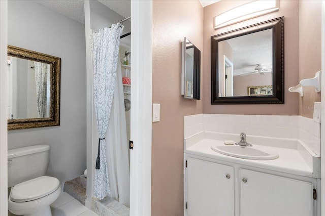 bathroom featuring tile patterned flooring, toilet, vanity, a textured ceiling, and curtained shower