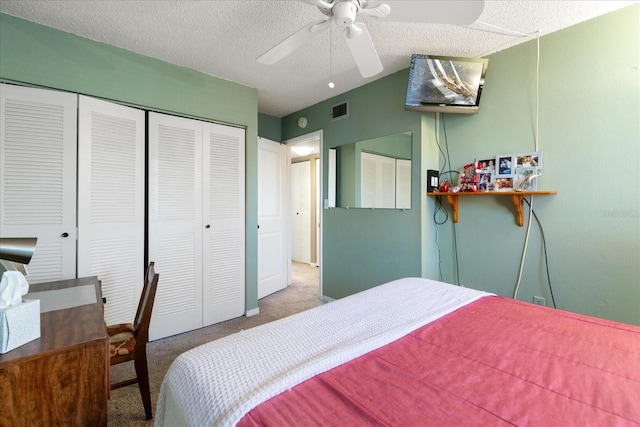 carpeted bedroom featuring a textured ceiling and ceiling fan