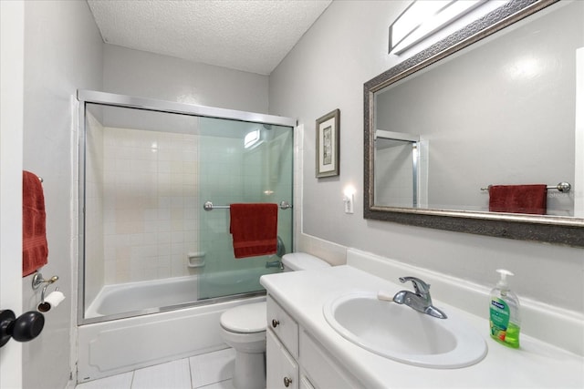 full bathroom featuring toilet, enclosed tub / shower combo, tile patterned floors, vanity, and a textured ceiling