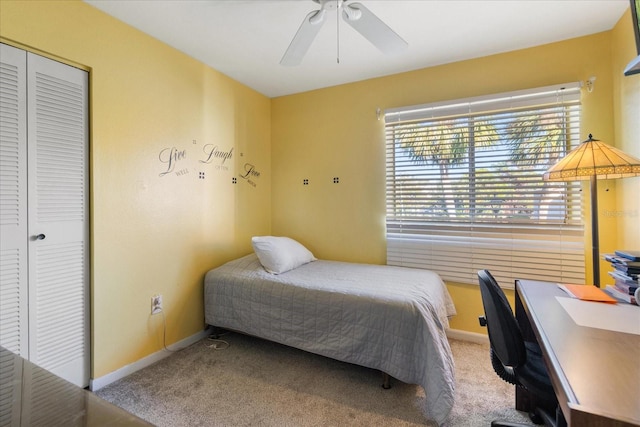 carpeted bedroom featuring a closet and ceiling fan