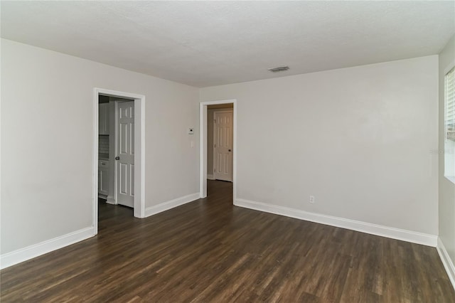 spare room featuring dark hardwood / wood-style flooring