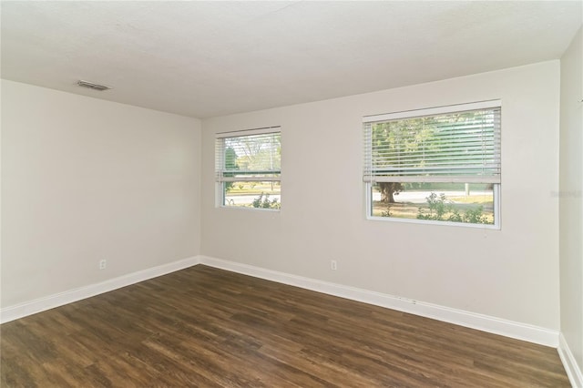 empty room featuring dark hardwood / wood-style flooring